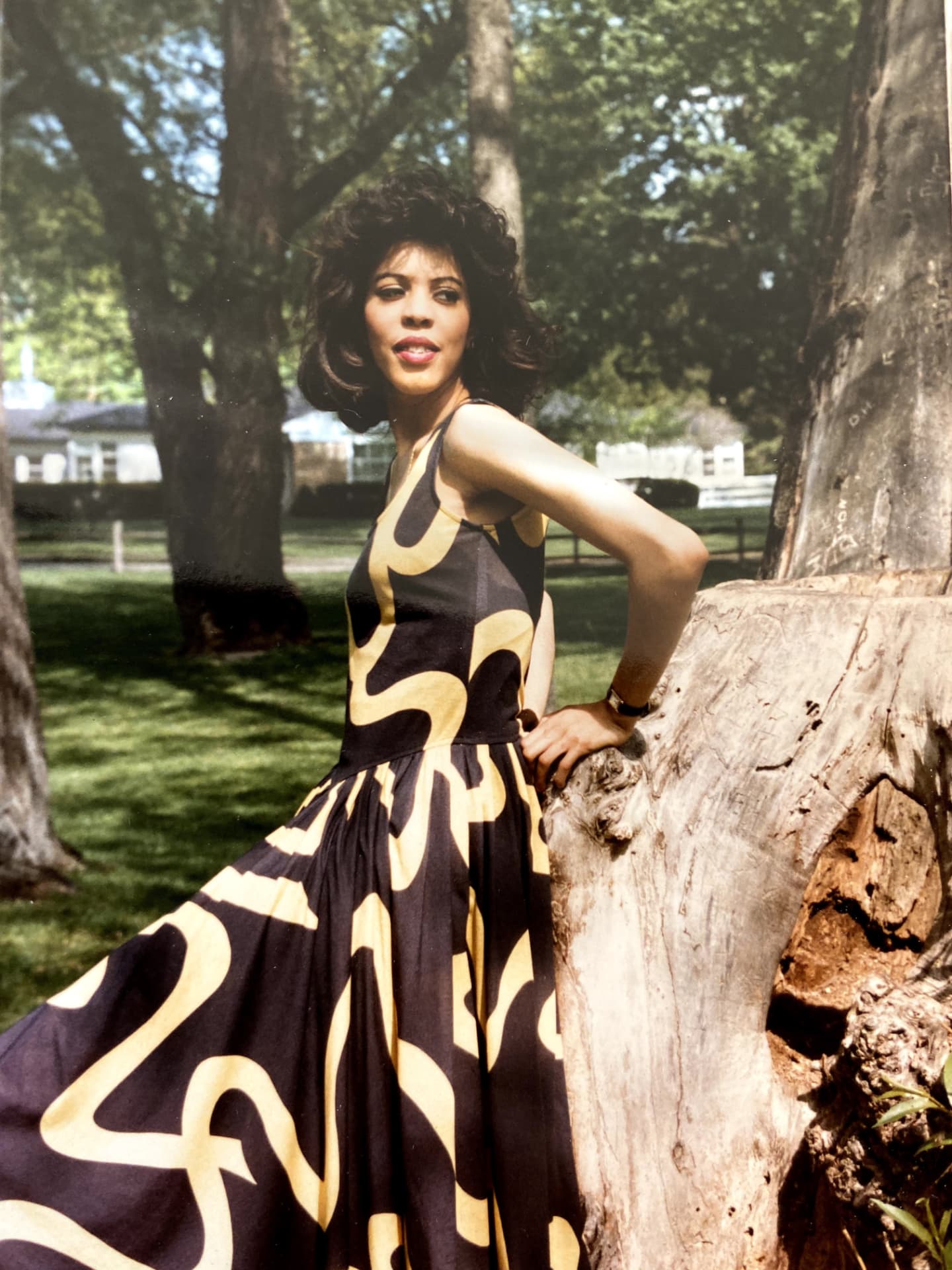 Karen in a black and gold swirl-print dress